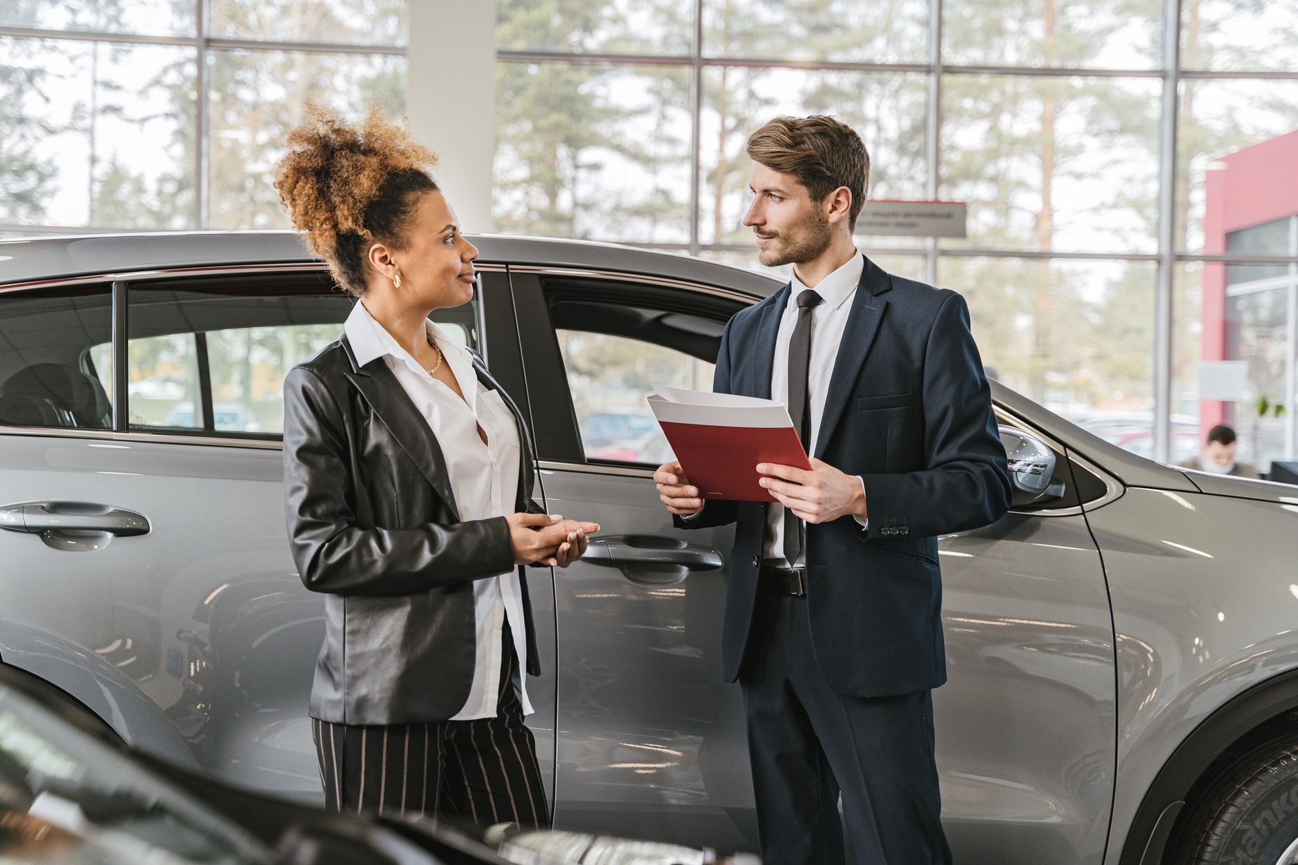 EV discounts UK dealers 2026 - finance paperwork being reviewed at a car dealership